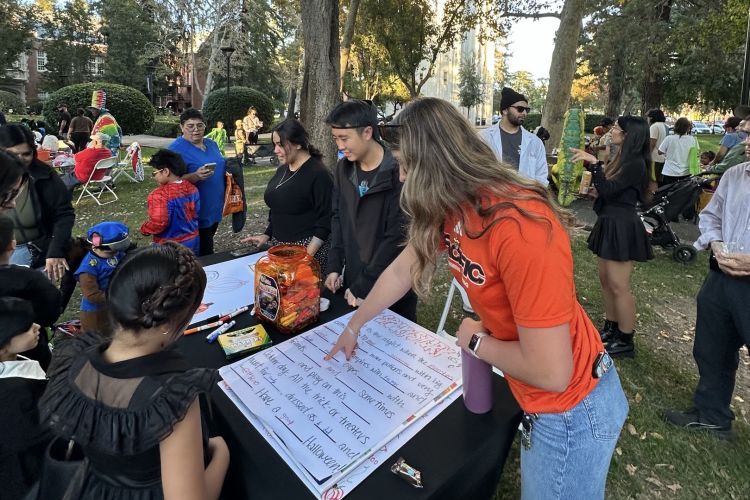 Students tabling for Pacific Trick or Treat