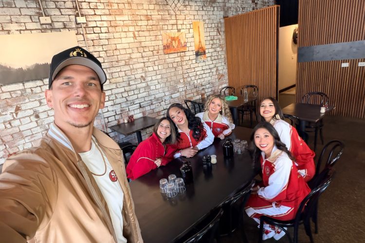 STUNT coach smiling in a selfie with the team
