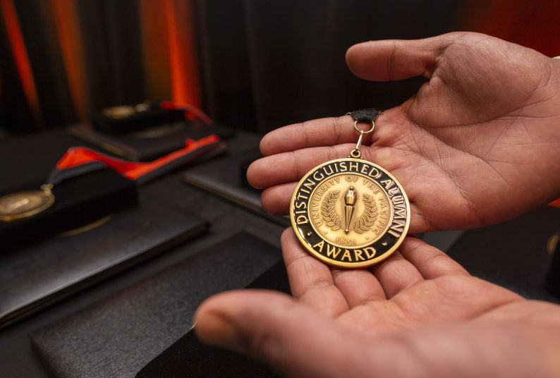 Hands holding medallion