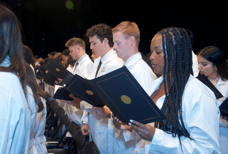 students reciting oath at White Coat Ceremony