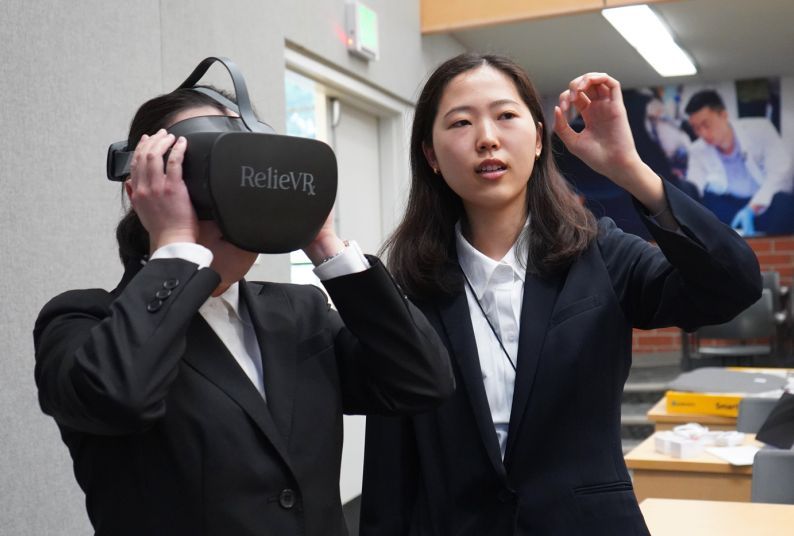 Two students from Tokyo University try a virtual reality headset