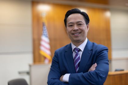 Photo of a man wearing a suit in a courtroom
