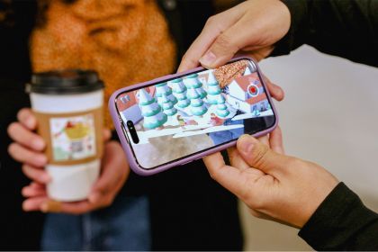 a person scans a QR code on a coffee cup