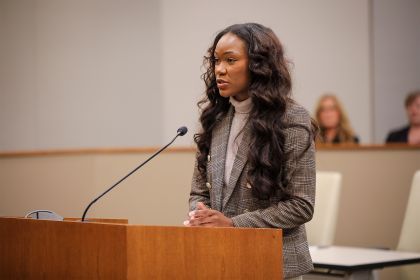 a law student stands at a podium