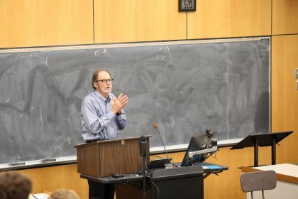 A professor stands at the front of a lecture hall at McGeorge School of Law teaching a class. 