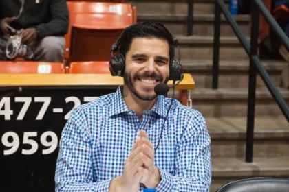 Zach Bayrouty sits with a headset on.