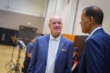 Dave Smart smiling in a blue suit