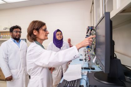 Professor Roshanak Rahimian points to a computer screen in her lab.