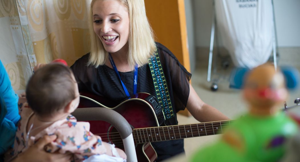 University of the Pacific MA in Music Therapy student Kathleen Humphries works with young patient during field visit.