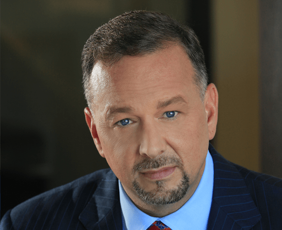 A close up portrait of a man in a suit