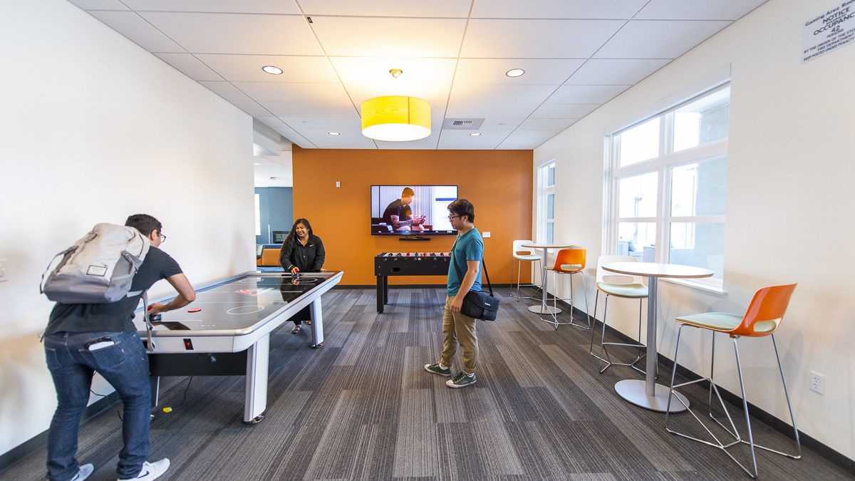 students playing air hockey in lounge