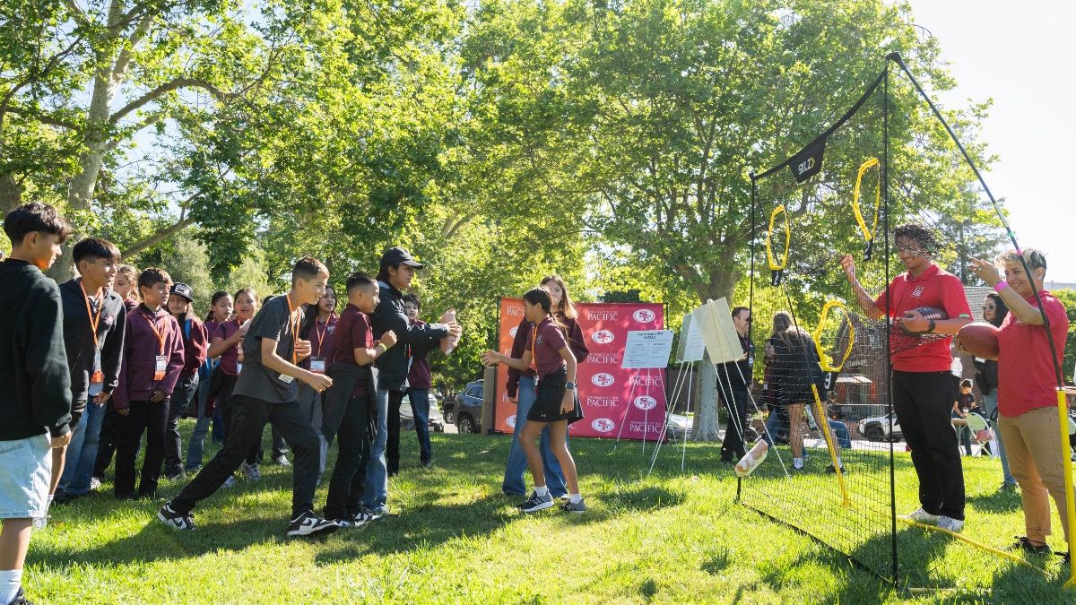Students throw paper footballs