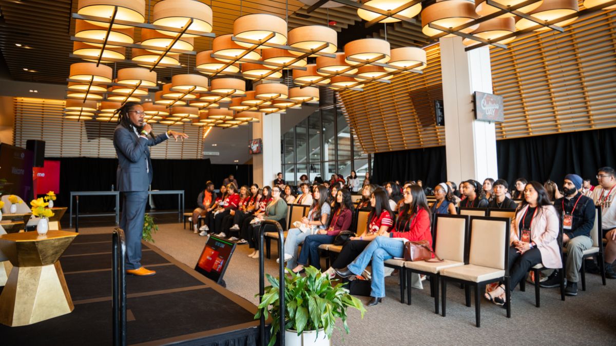 A large group of Pacific students sit together in a room at Levi's Stadium